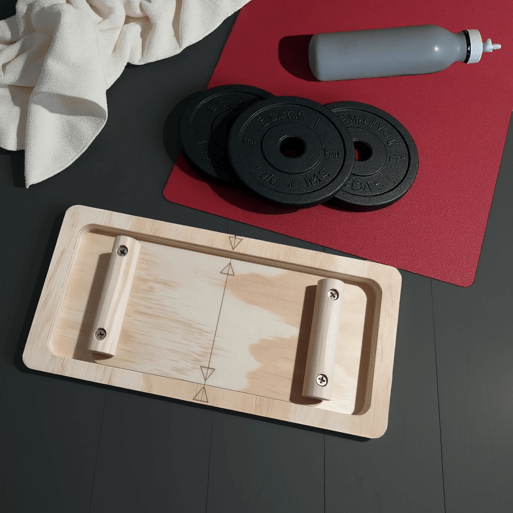 GripBattle Clash board beside a towel, beside a red mat with a grey water bottle and black weights on a dark surface.